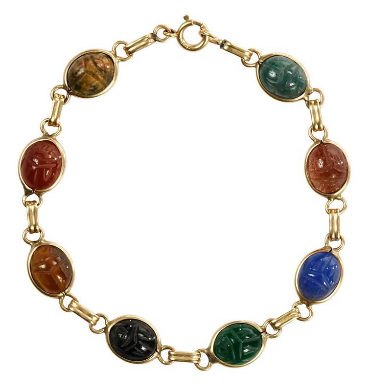 14kt. Scarab Bracelet: assorted carved gemstones including: sunstone, blood stone, tiger's eye, clasp stamped "14K", yellow gold, 3/8 in. wide, 7-1/2 in. lg., 8.0 grams, Provenance: Private Collection, Charlotte, North Caro