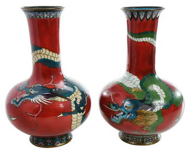 Near Pair of Red Cloisonne Figural Dragon Vases: Chinese, probably late 19th/early 20th century,ÿbottle form vases with cylindrical neck and ring foot, each depicting a dragon encircling the form, with geometric and floral decoration to rim and