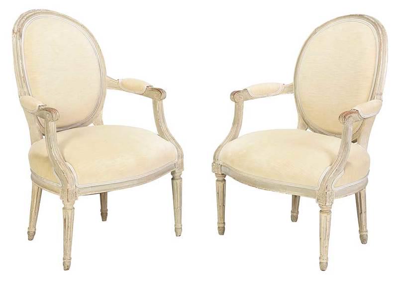 Pair Louis XVI Style White Painted Bergeres: Continental, 20th century, fluted legs and arms covered in a cream velvet upholstery, 36 x 24 x 23 in., Provenance: Private Collection, South Carolina