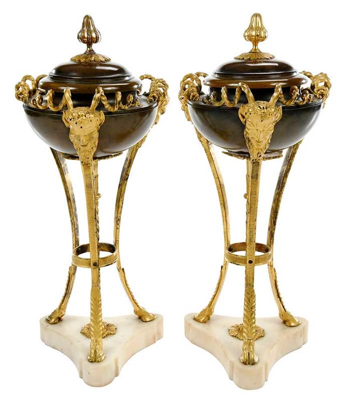 Pair Louis XVI Style Gilt and Bronze Cassolettes: 19th century, each comprising a shallow patinated bronze urn form and cover with gilt bronze finial, supported by three gilt bronze satyr masks with spiraling horns, terminating in hoof feet mounted o