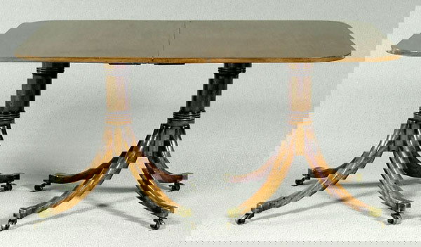 Regency-style mahogany dining table,: possibly Centennial, two tilt tops, two ring turned pedestals, with saber legs, brass cuffs and casters, solid mahogany, 30 x 57-1/2 x 41 in., opens to 102 in. with two leaves. Old refinishing, surfac