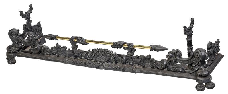 Victorian Brass and Iron Fire Fender: iron frame set with brass rail, mask figural tool rests, 14 x 55 x 15 in.