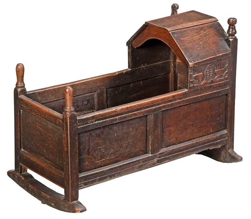 Charles II Carved and Joined Oak Cradle: British, 17th century, joined frame with relief carved panels with stylized leaves and flowers, lustrous brown color, turned finials, accompanied by 1963 receipt from John Bell of Aberdeen, Aberdeen,