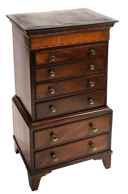 George III Mahogany Miniature Chest on Chest: British, early 19th century, highly figured veneers,˜light wood inlaid cornice, dovetailed drawers, pine secondary, on original tall bracket feet, mellow old surface, with label to drawer interior "C