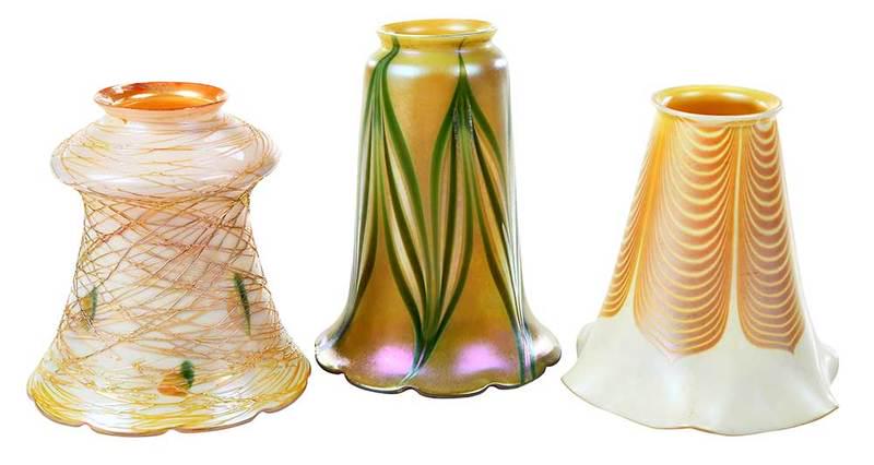 12 Quezal and Steuben Art Glass Shades: American, 20th century, six opaque iridescent white trumpet form shades, gold pulled feather design, gold iridescent interior, four with faint stenciled silver Steuben mark to fitter, each approximate