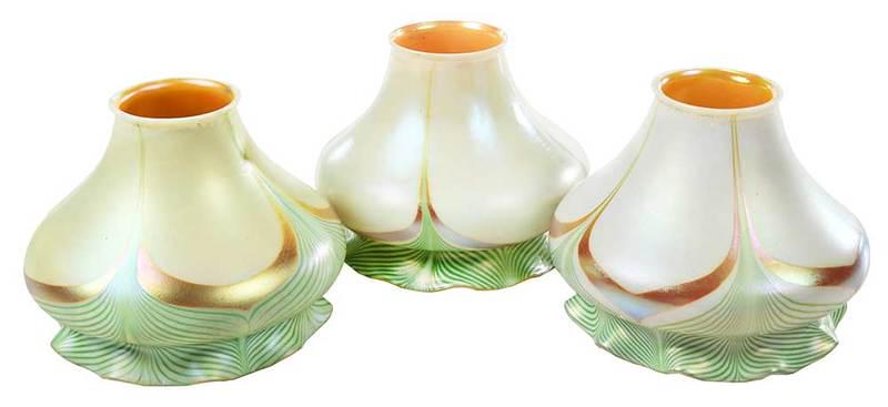Eleven Art Glass Shades, Possibly Steuben: American, 20th century, opaque iridescent white floriform shades, ruffled outer rim, green pulled feather design with gold tips, gold iridescent interior, some with silver smudge marks to fitter, each