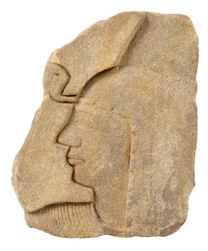 Egyptian Sandstone Relief Fragment of Face: probably ancient, exact age unknown, carved in sunken relief, depicting a fragment of a face in profile to the left, with downturned lips, wearing a collar, and wig covering left ear, with uraeus, and