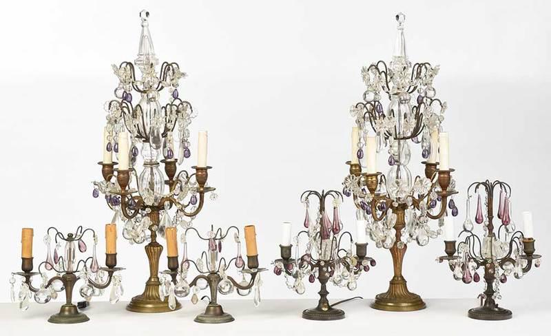 Three Pairs Venetian Style Candelabra Lamps: Italian, early 20th century, each with faceted crystal finial over chains of crystals with stars and rosettes and amethyst drops, four candle arms, wired for electricity, 29 in.; together with two sim