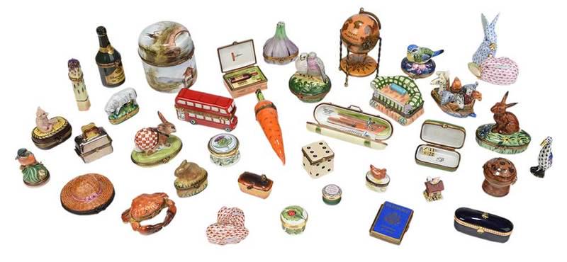 33 Porcelain Trinket Boxes, Three Herend Figures: Continental, 20th century, assorted porcelain and enameled hinged boxes, of varying forms, most with marks for "Limoges, France", three with marks for "Halcyon Days", one with marks for "Staffordshire