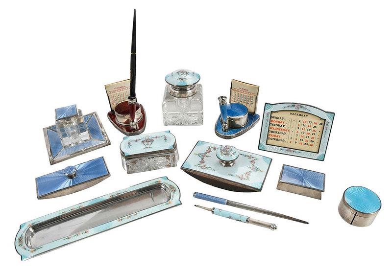 Two Sterling and Enamel Desk Sets, 15 Pieces: American, 20th century, two set with extras, all with enamel decoration, including blotters; inkwells; calendars; pens; stamp holders; calendar, stamp, pen holder holders; pencil; pen trays, most with