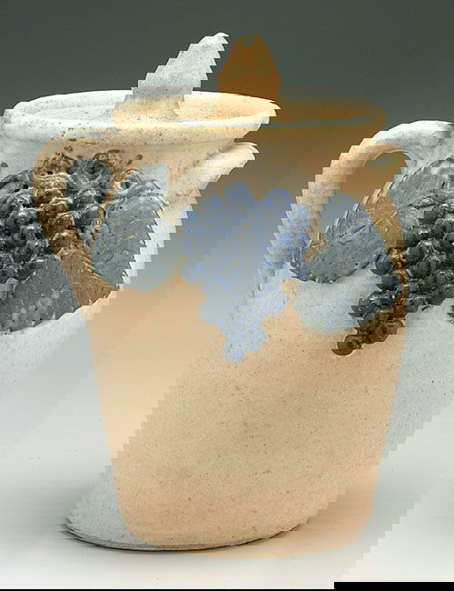 Lanier Meaders lidded canister, stonewar: Lanier Meaders lidded canister, stoneware, one loop handle, one ear, applied grape and vine decoration, runny white and beige glaze, base inscribed "LM" (Lanier Meaders), decoration probably by Arie M