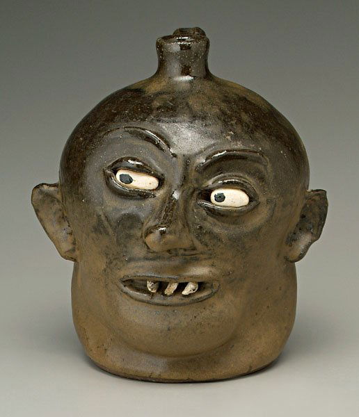 Lanier Meaders face jug,: Lanier Meaders face jug, alkaline glaze stoneware, ceramic eyes, three stone teeth, base marked "Lanier Meaders" (White County, Georgia, 1917-1998), 9-3/4 in. Excellent condition. Provenance: Private