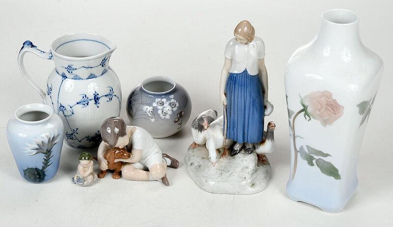 Eight Pieces Royal Copenhagen Porcelain: tall vase with rose decoration; two small floral vases; woman with geese, signed "Alex Locher"; boy with dog; two small mermaids; blue and white pitcher, 2 in. to 11 in., Provenance: Property of Twin 