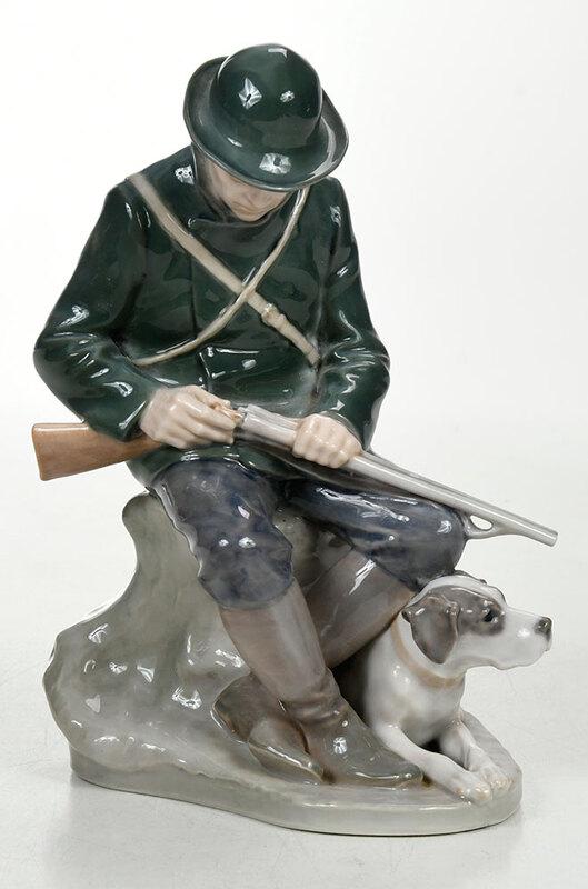 Royal Copenhagen Porcelain Figure of a Huntsman: Danish, 20th century, seated figure of a man with hound, Royal Copenhagen marks to base, 8-1/2 in., Provenance: Property from the Collection of the Late Parker B. Poe, Thomasville, Georgia, now the Pr