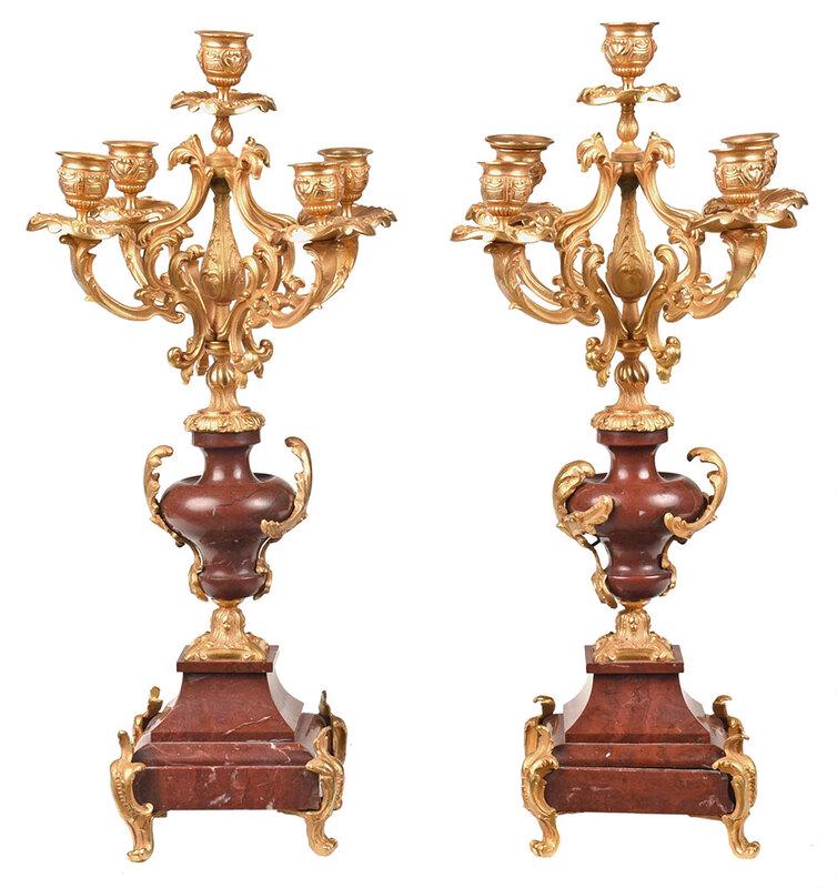Pair of Gilt Bronze and Marble Candelabra: probably French, 20th century, five gilt bronze arms mounted between a turned faux marble support and faux marble veneer base, gilt bronze mounts and paw feet, 20 in., Provenance: Private Charlotte Co