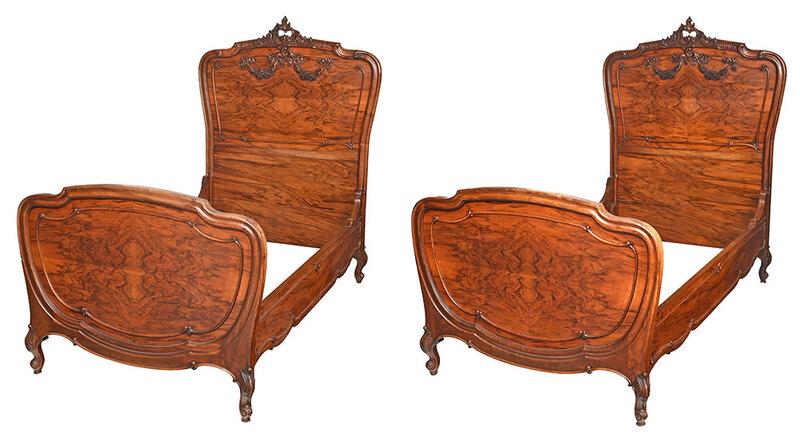 Pair Louis XV Style Carved Walnut Twin Beds: French, late 19th/early 20th century, each with leaf and rocaille carved crest, headboards with applied floral garlands, figured bookmatched walnut veneers, conforming carved and veneered rails,ÿ64 i