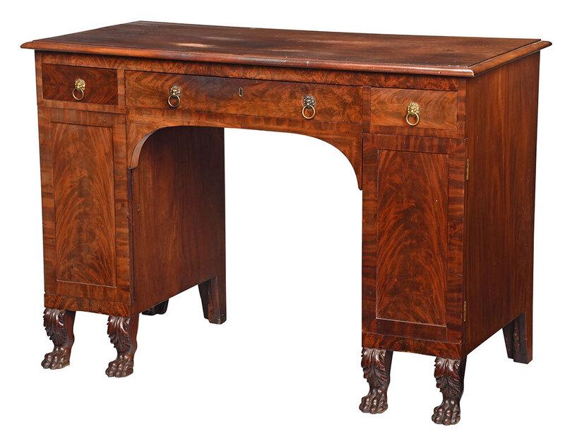Extremely Rare Figured Mahogany Table Desk: attributed to the shop of Duncan Phyfe, New York, 1810-1820, very finely crafted, with figured solid mahogany top, over three dovetailed frieze drawers, over two paneled cabinet doors opening to shelv