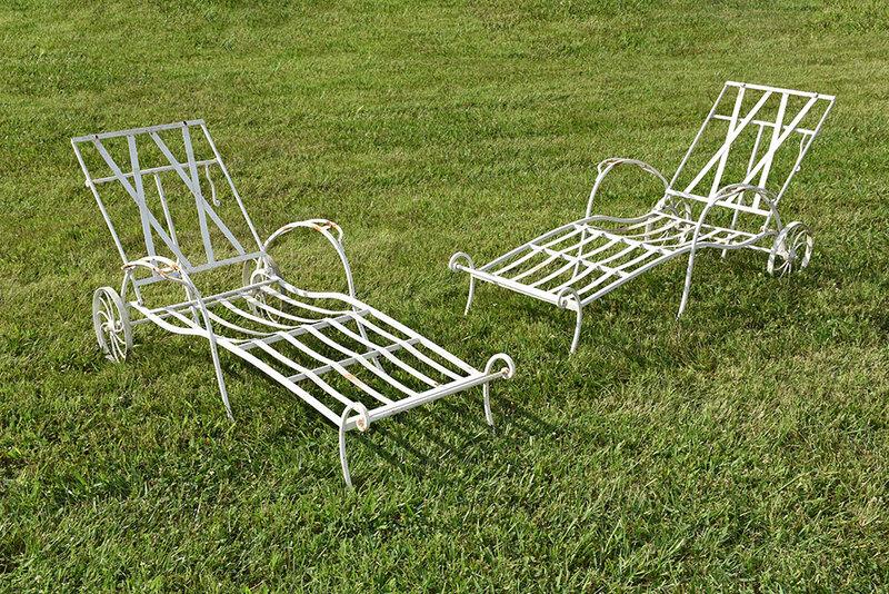 Two Wrought Iron Garden Chaises: American or European, mid-20th century, each with two wheels, adjustable back, slatted seats and back, back with cushion hangers, approx. 66 in. long, 36 in. with back at full height; Provenance: The