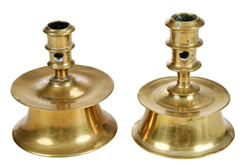 Two North European Brass Capstan Candlesticks: possiblyÿ16th century, each socket with single knop above twoÿround apertures, shallow mid-drip pan on a wide base with flared foot rim, 4-3/8 x 4-1/4 in.; 4-7/8 x 4 in.Note: A similar candlestick e