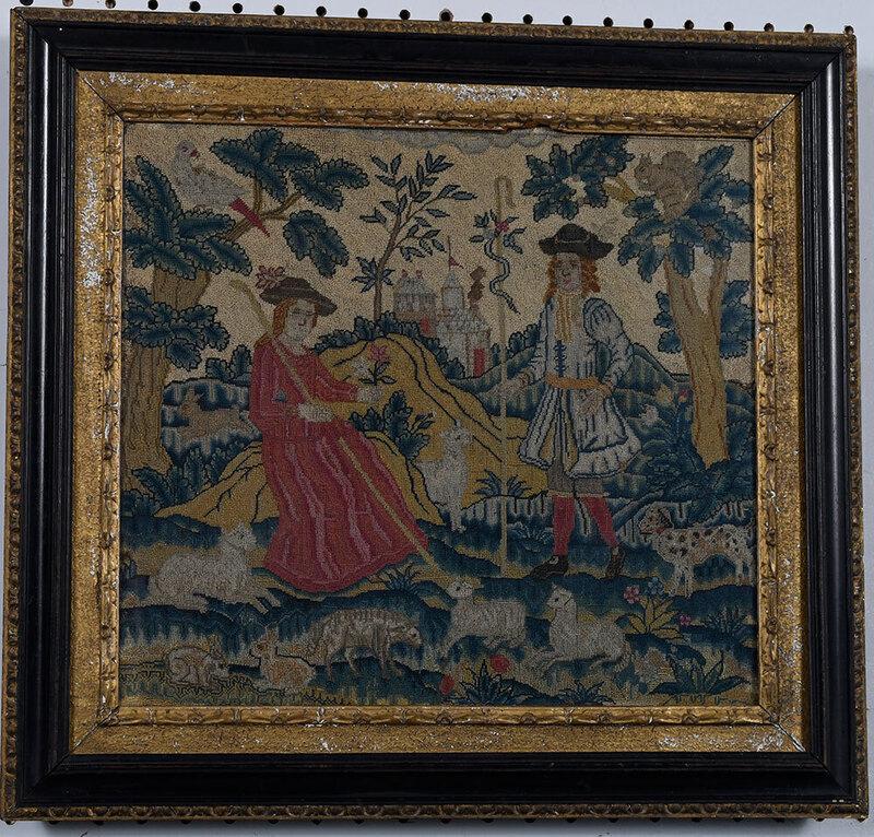 George II Wool and Silk Pastoral Needlework: British, mid 18th century, shepherd and shepherdess, with castle in the background and sheep, rabbits and a spotted dog in the foreground, wool tent stitch with silk embellishments on linen, 15 x 13-1