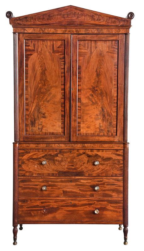 New York Federal Figured Mahogany Linen Press: possibly shop of Duncan Phyfe, circa 1815, highly figured veneers throughout, upper case with pitch pediment, over two paneled and Gothic arched veneered doors opening to three interior linen slides,
