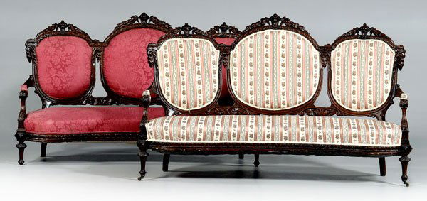 Pair rococo revival carved settees: elaborately carved walnut frames with upholstered backs and seats, one with pink-striped upholstery, one with silk damask upholstery, American, 19th century, 47 x 74 x 27 in. Scattered breaks and repa