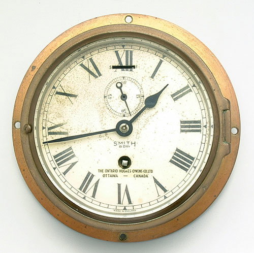 Circular ship's clock marked "Hughes Ow
