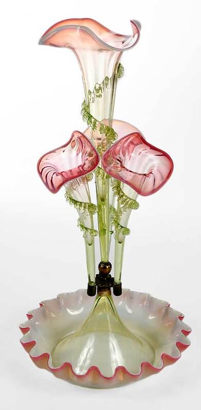 A Victorian Pink and Green Glass Epergne: late 19th century, central trumpet and three surrounding trumpets with spiraling rigaree decoration, on a round base with ruffled rim, 20 x 10-1/2 in. - Provenance: Private Collection, South Carolina