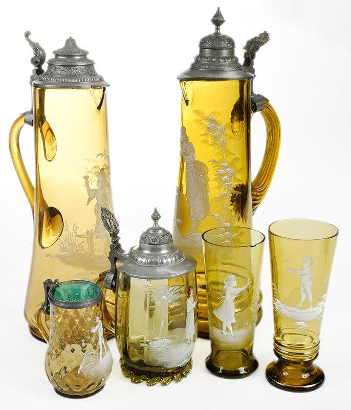 Six Pieces Mary Gregory Glass: Continental, early 20th century, all with white enamel decoration on olive colored glass, including two tall pewter covered steins; small glass covered stein; ribbed stein with pewter cover and ruffle