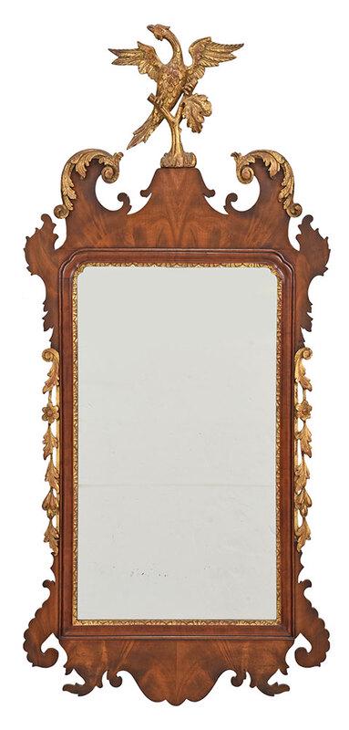 Chippendale Style Carved and Parcel Gilt Mirror: 20th century, mahogany, with spread wing phoenix crest, carved and gilt streamers, bookmatched veneers, 52 x 24 in. - Provenance: A Washington, D. C. Collection