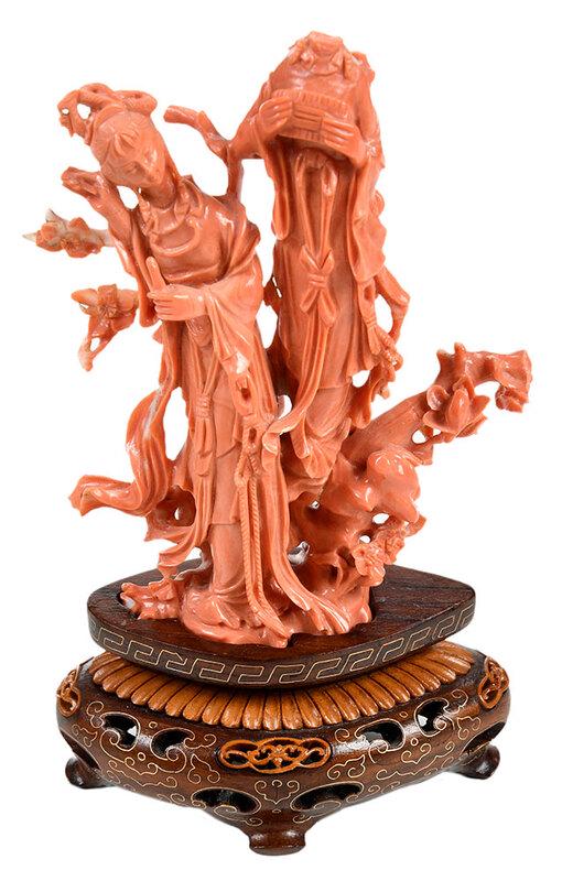Chinese Red Coral Carving of Two Maidens: Qing dynasty, figural group of twoÿmaidens standing behind a scholar's stone and flowering tree with sprawling branches, all together approximately 10 x 7 in.; with carved wooden standÿNote: