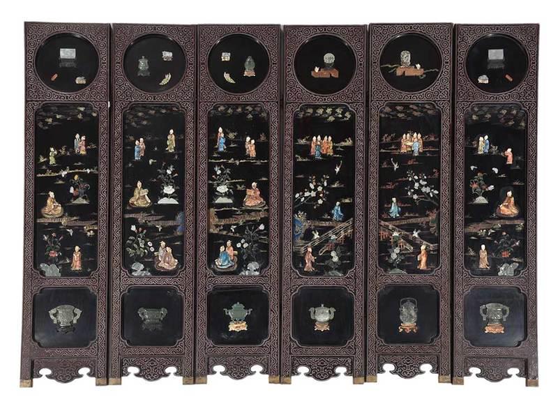 Chinese Lacquer and Stone Six Panel Floor Screen: late 19th century, each panel set with applied carved stone, wood, and bone figures and precious objects, on gilt and polychrome decorated ground, reverse decorated with gilt and polychrome landscape 