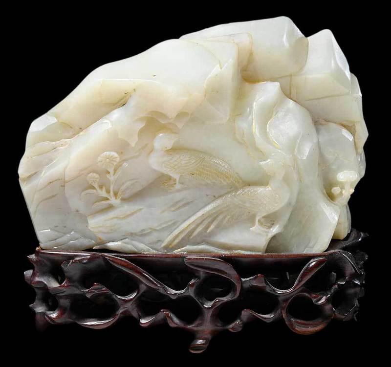Chinese Carved Jade Boulder and Wood Stand: rocky outcrop with birds, on a carved and pierced wooden stand, 6 in.ÿ - Provenance: Private Collection, Georgia