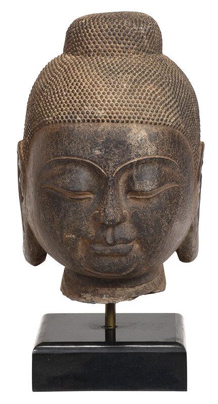 Carved Stone Buddha Head Mounted on Marble Base: Asian, age unknown, face with serene expression and eyes cast downward, mounted with metal rod to sit on black marble base, head only 18 in.; overall 23 in.ÿ - Provenance: Collection of Russell C