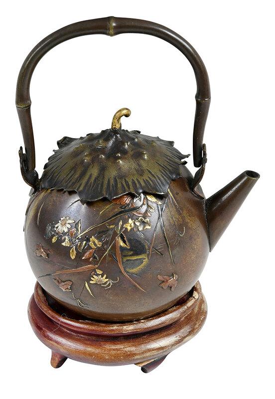 Japanese Aesthetic Movement Mixed Metals Teapot: probably Meiji period, round patinated bronze form with branches cascading from the rim, with blossoms, songbirds, incised calligraphic inscription, gilt and copper highlights, bamboo form swing handl