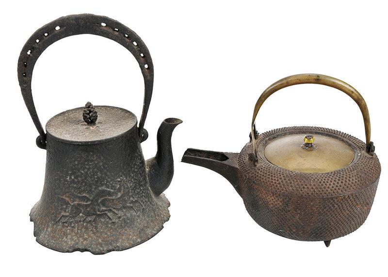 Two Japanese Iron and Brass Lidded Teapots: 19th century, one bell form with pierced bail handle, mountain and running horse decoration, lid with pine cone finial, height 9 in.; wide round form on tripod feet, brass handle and lid with beaded f