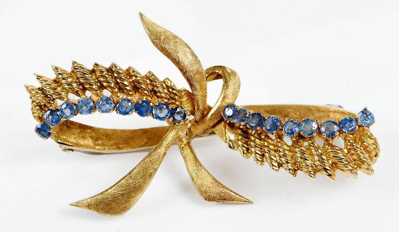 18kt. Sapphire Brooch: bow design, 18 round faceted blue sapphires approx. 2.2mm each, stamped "237AL, Italy, K18, 750", yellow gold, 1 x 1-7/8 in., 9.7 grams - Provenance: The Miller White Willis Mott Moore Collection, New