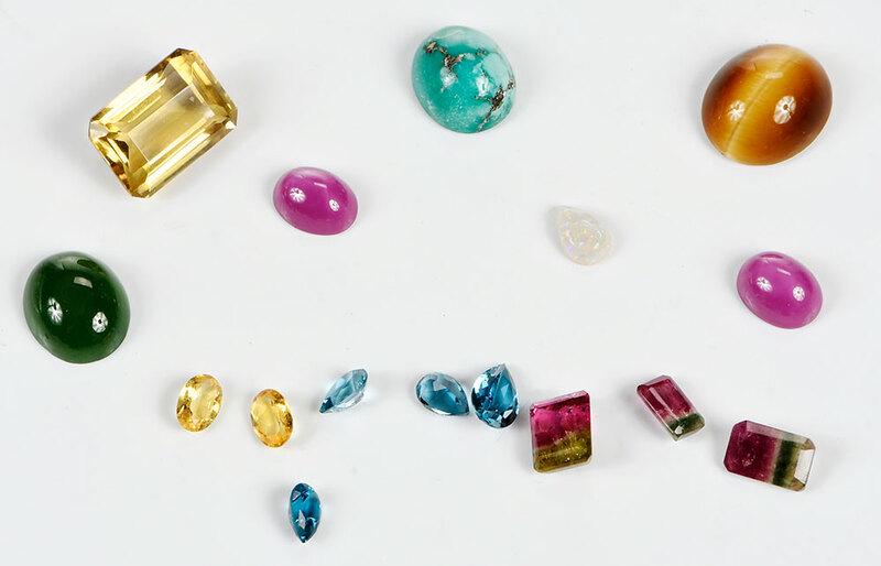 Large Group Assorted Loose Gemstones: faceted and cabochon synthetic and natural stones including: lindy star ruby and sapphire, watermelon tourmaline, opal, marcasite, black onyx, opal doublets, carved stones and assorted synthetic and i