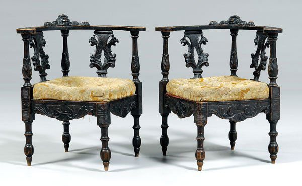 Pair baroque style carved corner: chairs: each with central carved cherub mask on crest, griffin and pierce-carved splats, needlework seats, carved skirts and legs, probably Italian, late 19th century, 29-3/4 x 27-1/2 x 26 in. General
