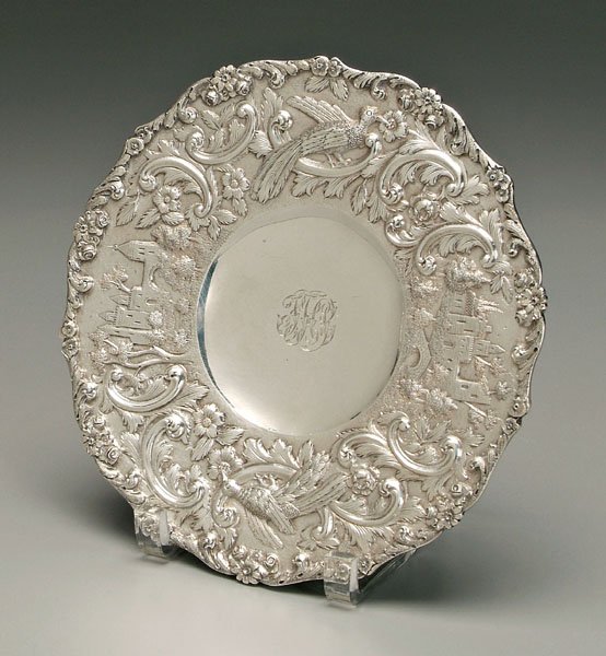 Repousse sterling footed plate,: floral, bird and architectural repousse border, base marked "The Loring Andrews Co./Cincinnati U.S.A.", probably retailer, possibly Baltimore, Maryland maker, monogram, 13.53 oz.T., 1 x 9 in. Light sc