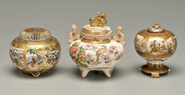 Three Satsuma tripod censers:: one with cartouches of women and children, base with gold Gyokuzan mark, 4-1/2 in., [replaced lid with repairs;] one with Buddhist lion finial, shaped handles, Shimazu crest in leaf and vine border, e