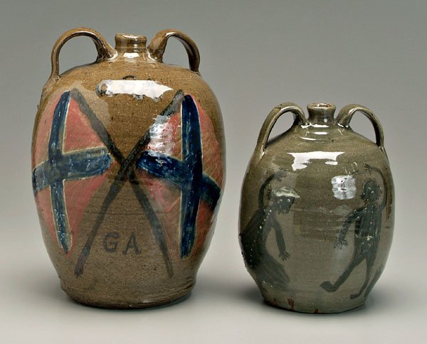 Two Chester Hewell Confederate jugs: (Gillsville, Georgia, born 1950): both alkaline glaze stoneware, one side of each with Confederate flags and "CSA/GA", other sides with male and female figures dancing, conjoined monogram "CH" on hand