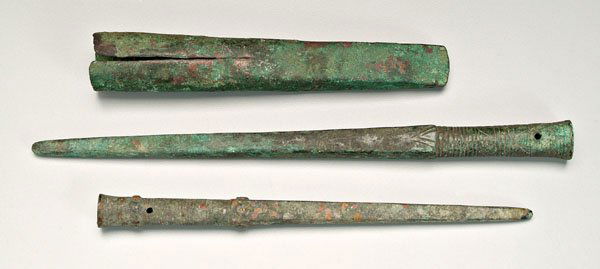 Three ancient bronze spear points: two decorated, round mounts with circular and incised decoration, square tapering end, 10-5/8 in. and 13-3/8 in.; heavy pointed object, possibly a weapon or tool, 9 in., [long separation,] probably Lu