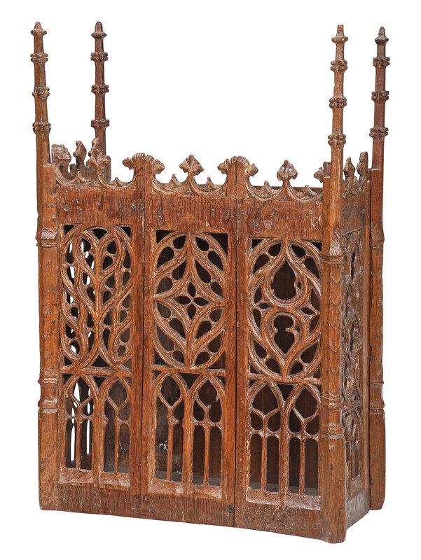 Fine Gothic or Gothic Style Carved Oak Reliquary: British or Continental, exact age unknown, with tall spire finials and Gothic tracery panels, triple panel front and panels on each side, opens from the back, 31-1/2 x 20-1/2 x 10 in. - Provenance: Es
