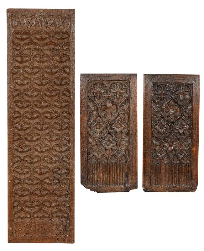 Three Gothic or Gothic Style Carved Oak Panels: Continental, possibly 16th/17th century, comprising a pair of rectangular panels, Gothic arch, floral, and fleur de lis motifs, each 18 x 8-1/2 in.; long rectangular panel, interlocking scroll motif, 