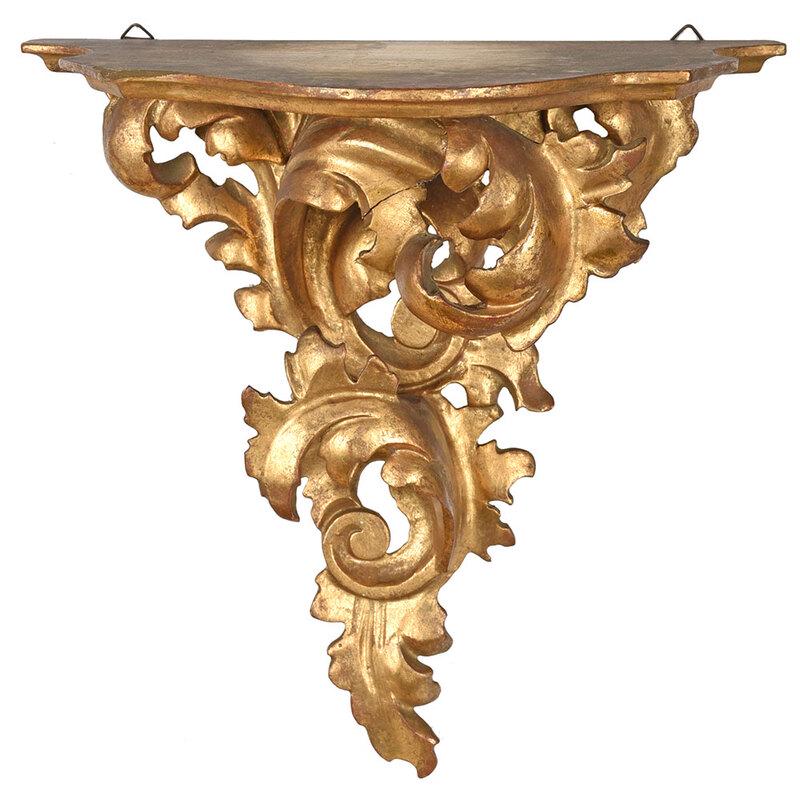 Italian Rococo Style Giltwood Wall Bracket: early 20th century, scrolled foliate support, flat shelf, stamped "Made in Italy" verso, two metal hanging hooks, 11-1/8 x 10-6/8 x 6-7/8 in. - Provenance: Collection of Dr. Joseph T. and Gaile E. Win