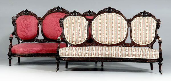 Pair rococo revival carved settees: elaborately carved walnut frames with upholstered backs and seats, one with pink-striped upholstery, one with silk damask upholstery, American, 19th century, 47 x 74 x 27 in. Scattered breaks and repa