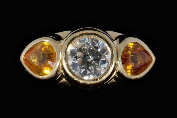 Diamond, golden sapphire ring,: central Old European-cut diamond, estimated weight 1.07 cts., color I to J, clarity SI-2, flanked by two faceted pear golden sapphires, total estimated weight 1.26 cts., 18 kt. yellow gold mount, mark