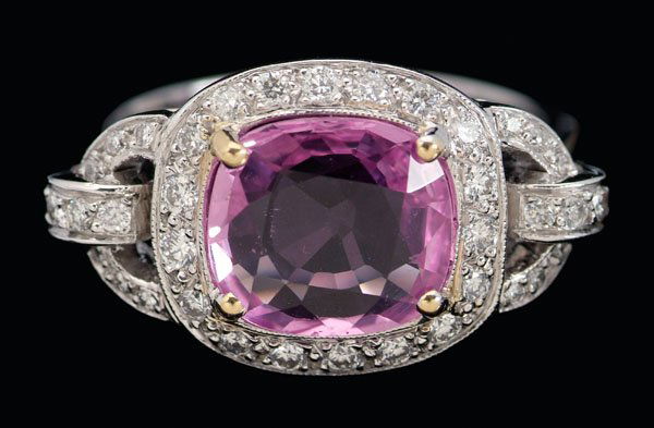 Pink sapphire, diamond ring,: central cushion faceted sapphire, estimated weight 3.19 cts., strong pink color, accented with 30 round brilliant-cut diamonds, total estimated weight .67 cts., 18 kt. white gold mount, size 8-1/2; in