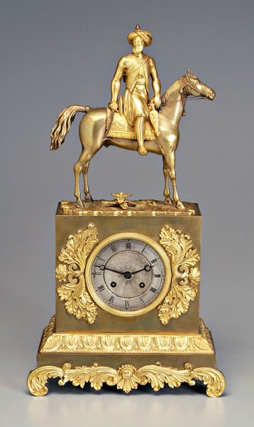 Bronze doré and brass mantle clock,: pediment with Turkish soldier astride horse, base with ormolu mounts with scrolls and petals, silvered dial with Roman numerals, brass works, key wind, with pendulum and key, probably Continental, lat